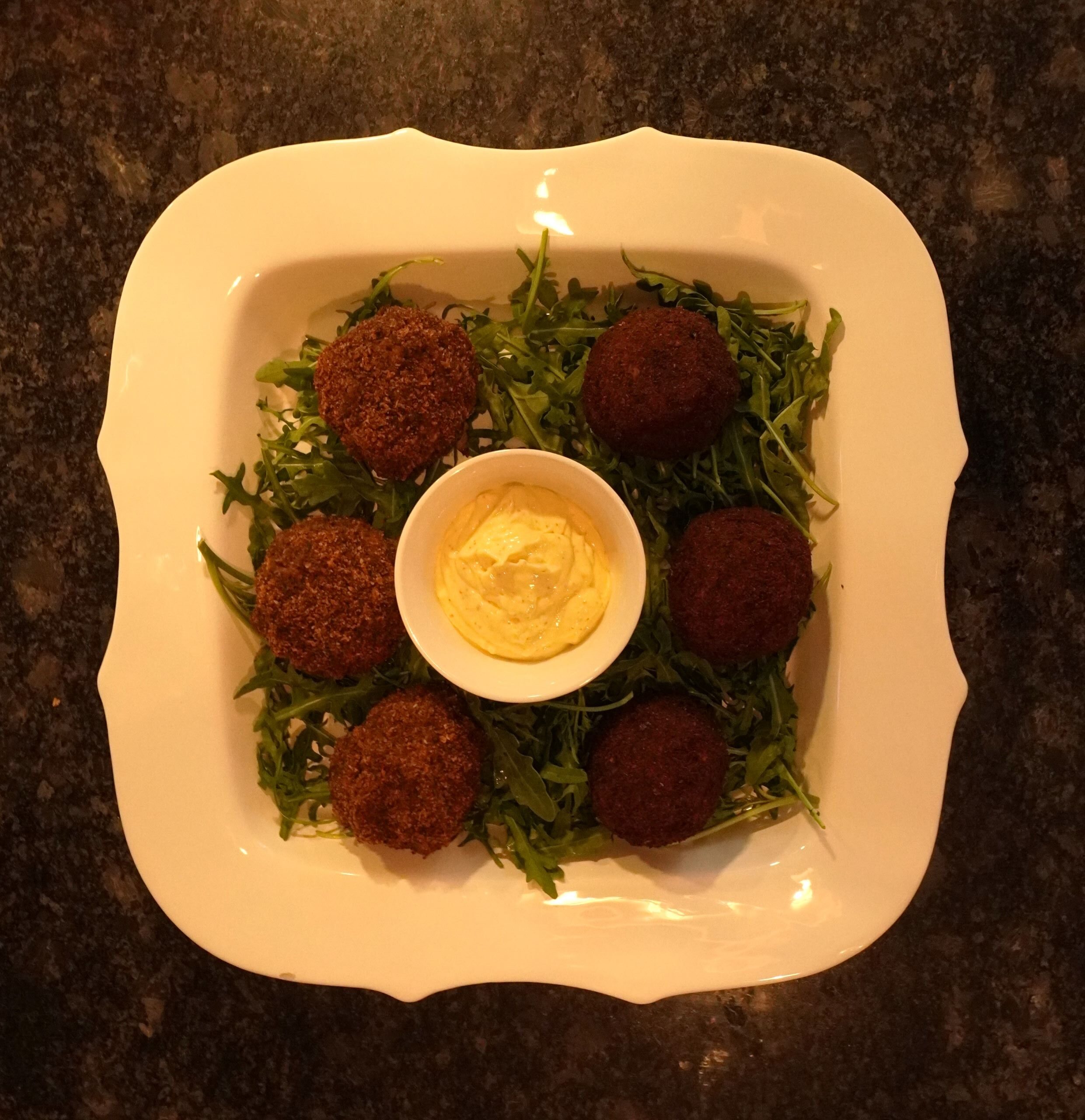 aerial shot of of the best scotch eggs plated with arugula